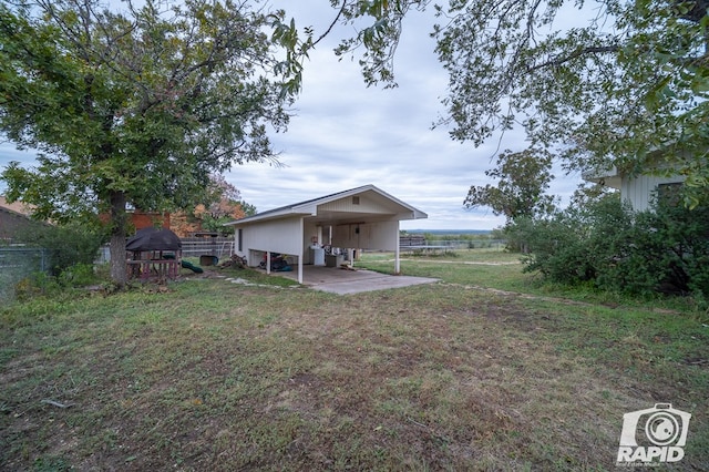 view of yard with a playground and fence