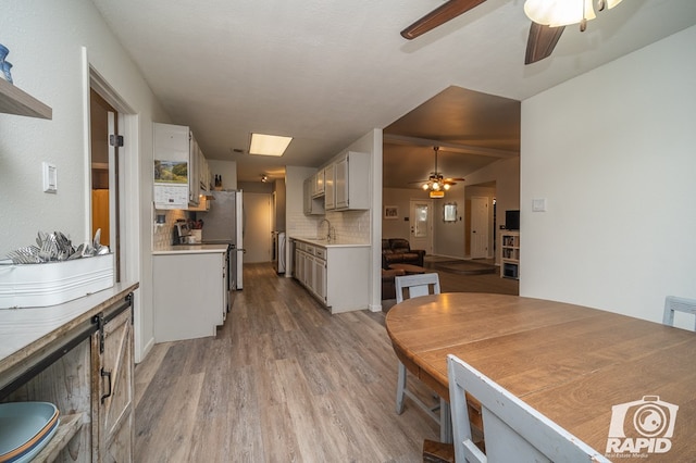 dining space featuring ceiling fan and light wood finished floors