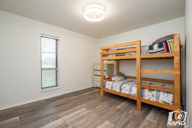 bedroom featuring wood finished floors and baseboards