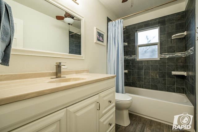 full bathroom featuring toilet, wood finished floors, vanity, and shower / bath combo with shower curtain