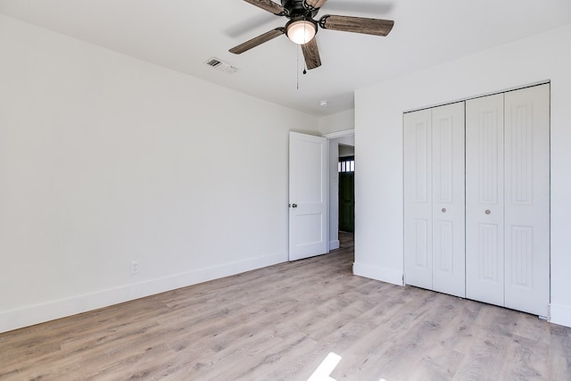 unfurnished bedroom with ceiling fan, a closet, and light hardwood / wood-style flooring