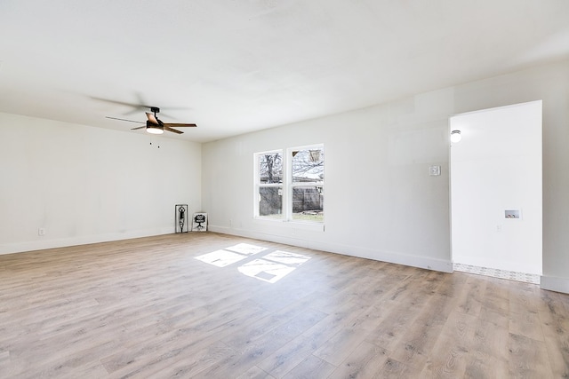 empty room featuring ceiling fan and light wood-type flooring