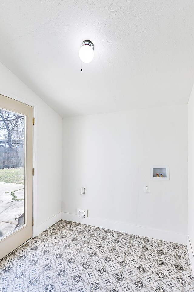 empty room featuring vaulted ceiling and a textured ceiling