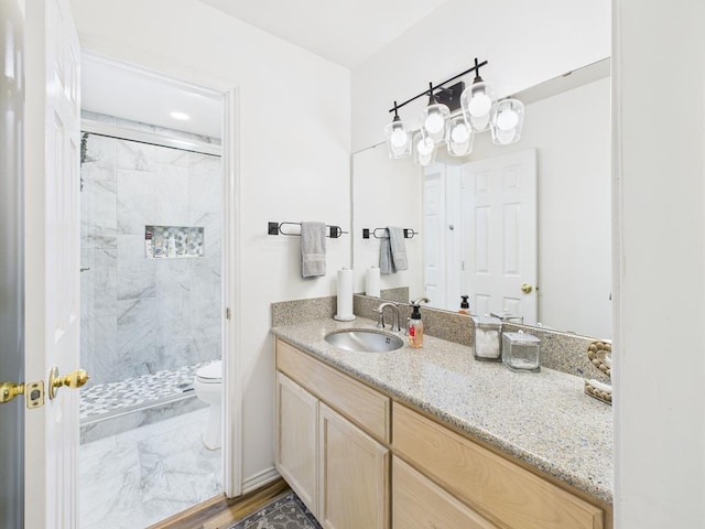 675 Buffalo Ln, San Angelo, TX 76901 - bathroom with marble look tiles, vanity, and a stall shower