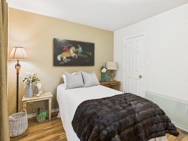675 Buffalo Ln, San Angelo, TX 76901 - bedroom with wood finished floors and baseboards