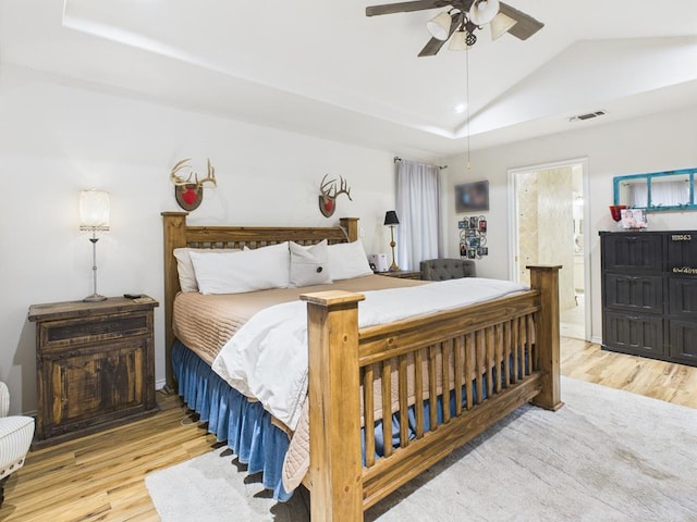 675 Buffalo Ln, San Angelo, TX 76901 - bedroom featuring wood finished floors, lofted ceiling, ensuite bath, and a ceiling fan