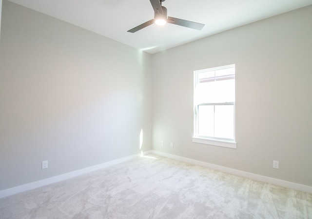 unfurnished room with light carpet, ceiling fan, and baseboards