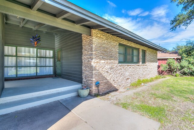 view of property exterior with a patio area