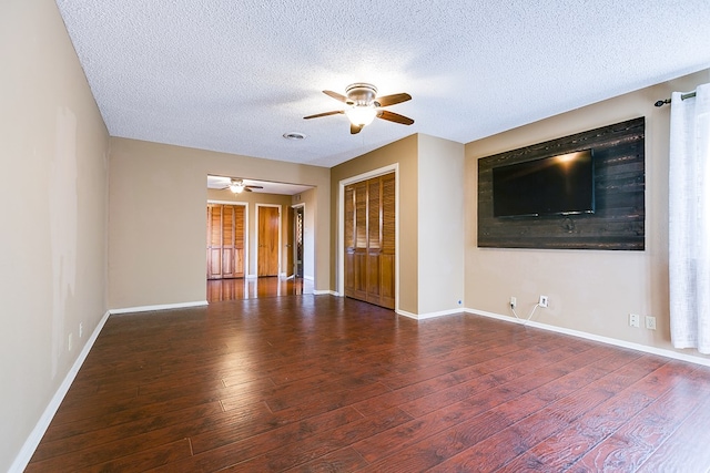 unfurnished living room featuring ceiling fan, hardwood / wood-style floors, and a textured ceiling