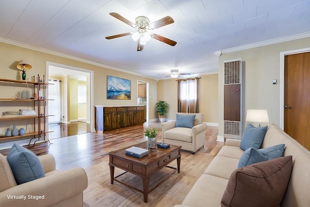 living room with ornamental molding, a healthy amount of sunlight, ceiling fan, and light wood-type flooring