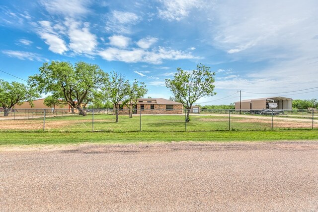 view of front of property with a carport, fence private yard, and a front yard