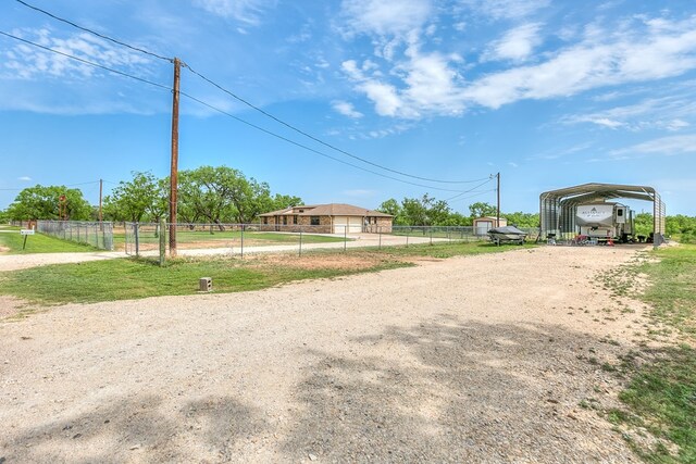 view of road with dirt driveway
