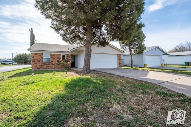 single story home featuring a front yard, brick siding, concrete driveway, and an attached garage