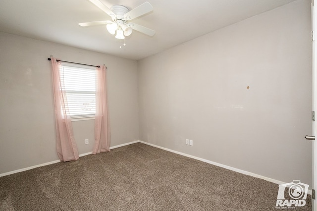 unfurnished room with baseboards, dark carpet, and a ceiling fan