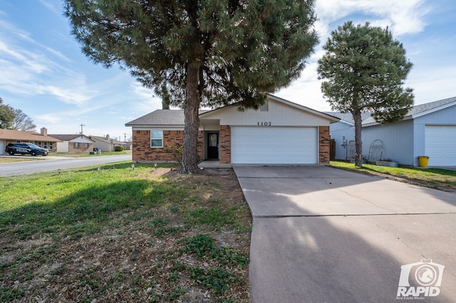 ranch-style house featuring brick siding, an attached garage, concrete driveway, and a front lawn