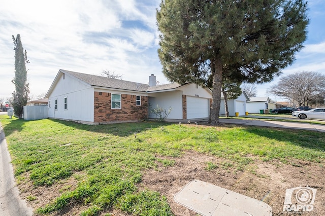 ranch-style home with brick siding, a front lawn, concrete driveway, a chimney, and an attached garage