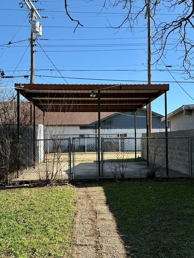 view of car parking featuring a lawn and a carport