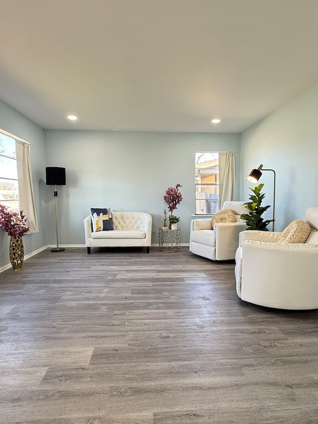 unfurnished living room featuring a healthy amount of sunlight and hardwood / wood-style floors