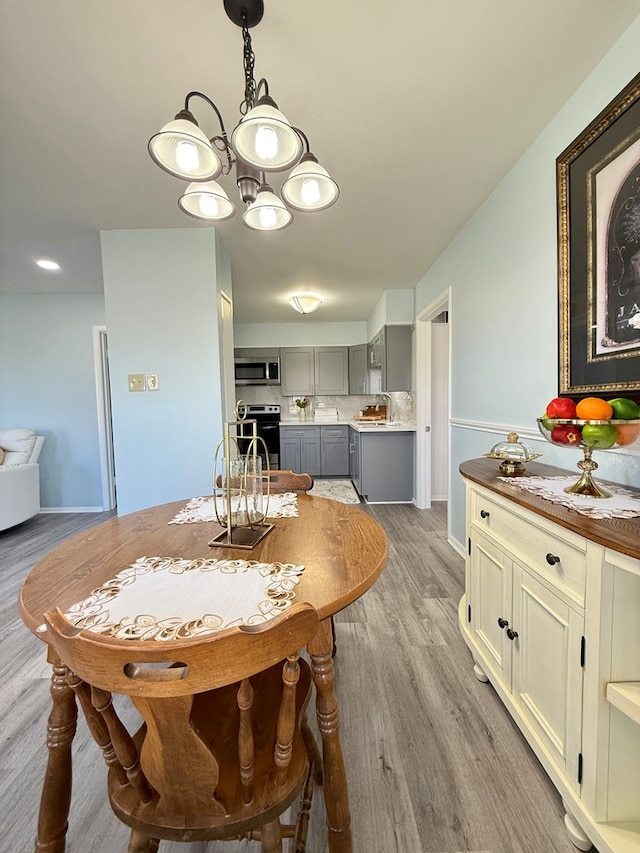 dining room featuring sink and light wood-type flooring