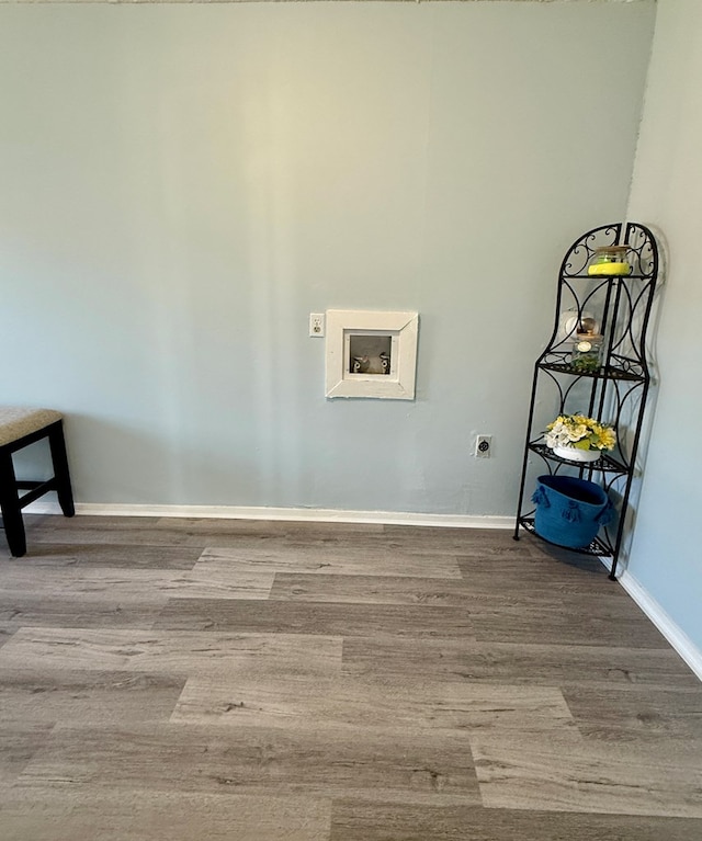 laundry area with hookup for an electric dryer, hookup for a washing machine, and hardwood / wood-style floors