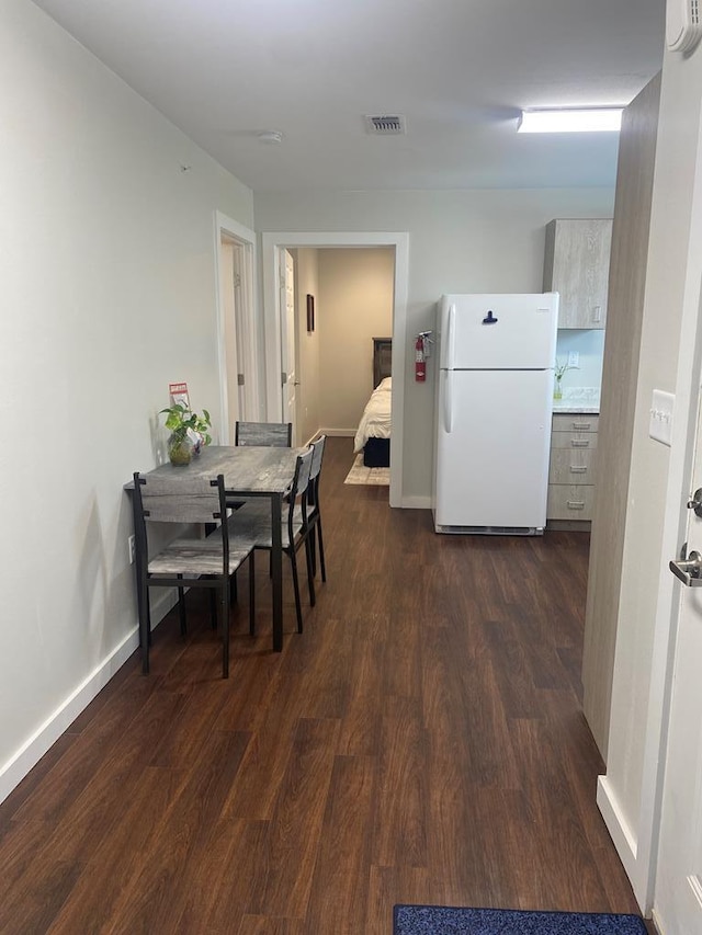 dining area with dark hardwood / wood-style floors