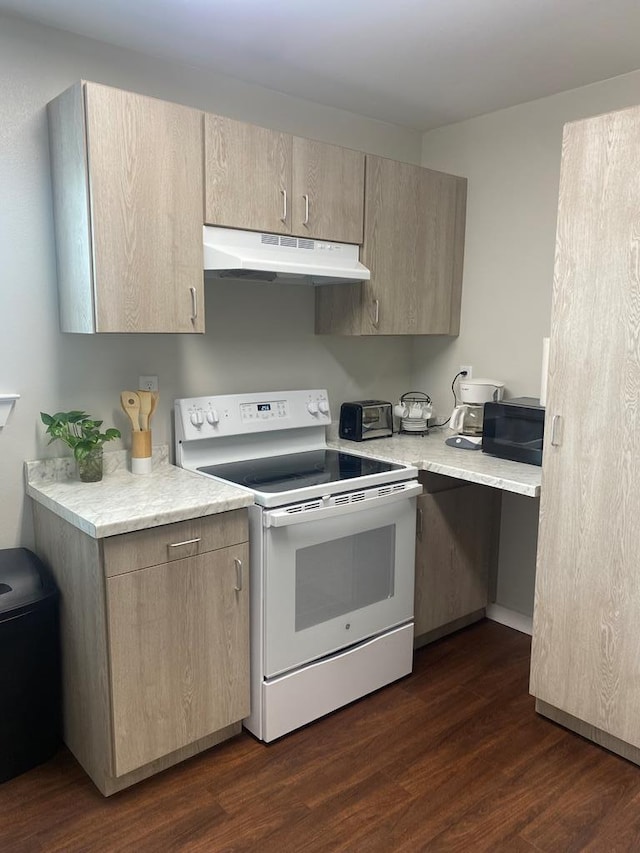 kitchen featuring electric range, dark wood-type flooring, and light brown cabinets