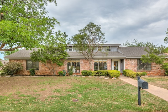 3626 Willowbrook Dr, San Angelo, TX 76904 - traditional-style house featuring a shingled roof, brick siding, and a front yard