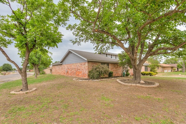 3626 Willowbrook Dr, San Angelo, TX 76904 - exterior space featuring brick siding and a front lawn