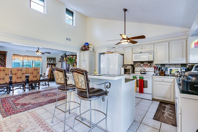 3626 Willowbrook Dr, San Angelo, TX 76904 - kitchen with a ceiling fan, white appliances, light tile patterned floors, and high vaulted ceiling