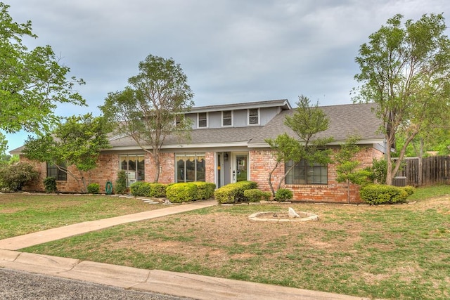 3626 Willowbrook Dr, San Angelo, TX 76904 - view of front facade with roof with shingles, brick siding, a front lawn, and fence