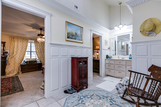 3626 Willowbrook Dr, San Angelo, TX 76904 - interior space with a notable chandelier, visible vents, a towering ceiling, light carpet, and light tile patterned flooring