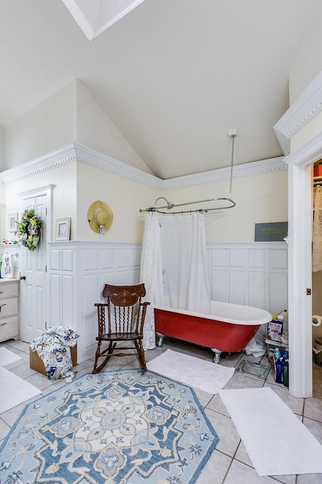 3626 Willowbrook Dr, San Angelo, TX 76904 - living area with light tile patterned flooring, a decorative wall, wainscoting, and lofted ceiling