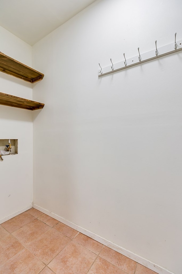 3634 Old Post Cir, San Angelo, TX 76904 - laundry area with light tile patterned floors, hookup for a washing machine, and baseboards