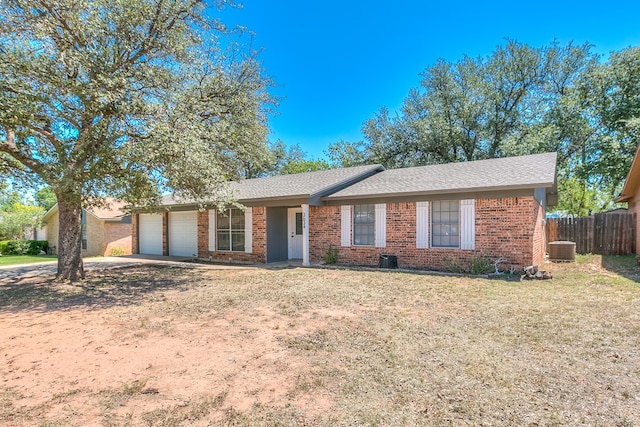 3634 Old Post Cir, San Angelo, TX 76904 - ranch-style home with a garage, brick siding, central air condition unit, and concrete driveway