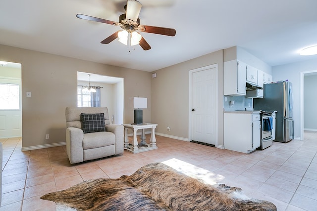 3634 Old Post Cir, San Angelo, TX 76904 - living area featuring light tile patterned floors, a ceiling fan, baseboards, and a chandelier
