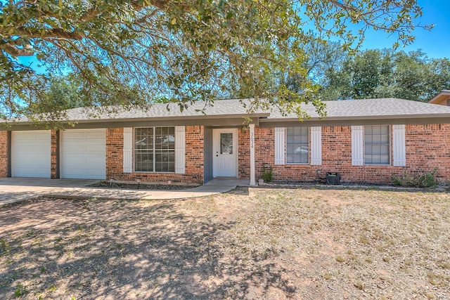 3634 Old Post Cir, San Angelo, TX 76904 - ranch-style house featuring an attached garage, brick siding, concrete driveway, and a shingled roof
