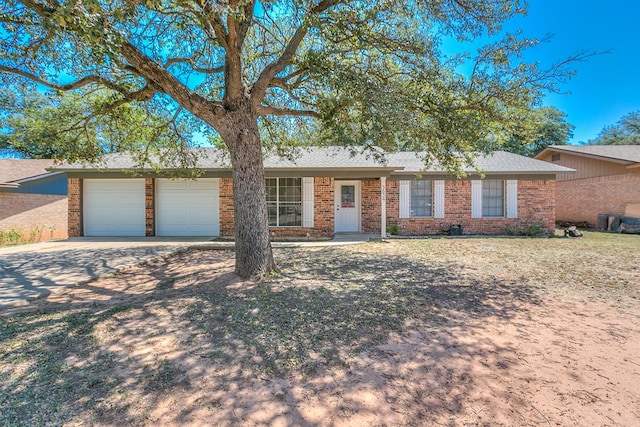 3634 Old Post Cir, San Angelo, TX 76904 - ranch-style house featuring an attached garage, concrete driveway, and brick siding