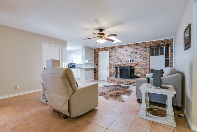 3634 Old Post Cir, San Angelo, TX 76904 - living area featuring ceiling fan, light tile patterned floors, a fireplace, brick wall, and baseboards