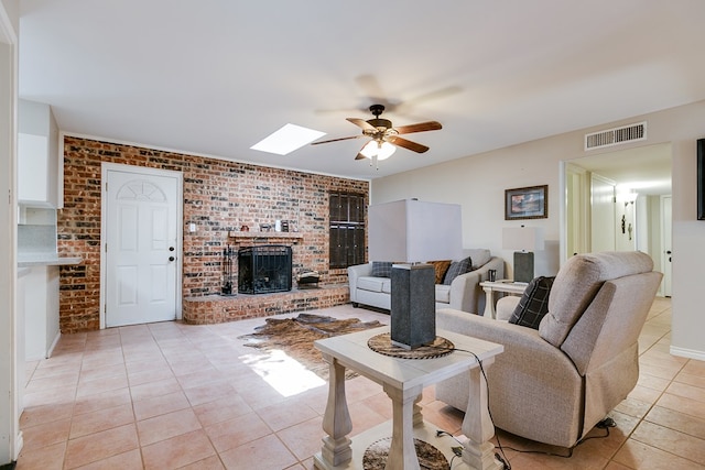 3634 Old Post Cir, San Angelo, TX 76904 - living area with a ceiling fan, a brick fireplace, light tile patterned floors, brick wall, and a skylight