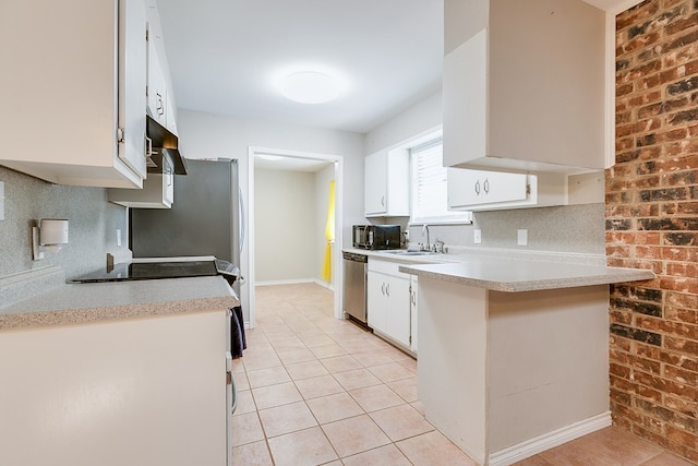 3634 Old Post Cir, San Angelo, TX 76904 - kitchen featuring stainless steel dishwasher, black microwave, light countertops, tasteful backsplash, and brick wall