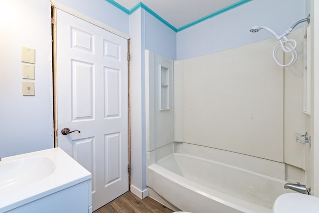 full bathroom featuring washtub / shower combination, vanity, toilet, and hardwood / wood-style floors