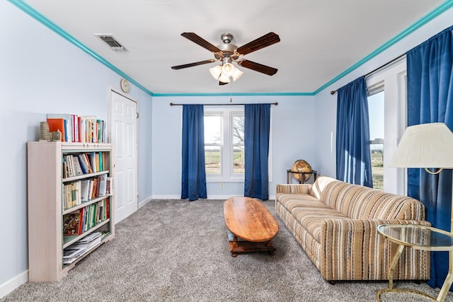 sitting room featuring ornamental molding, carpet, and ceiling fan