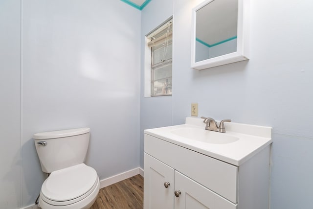 bathroom with vanity, hardwood / wood-style flooring, and toilet