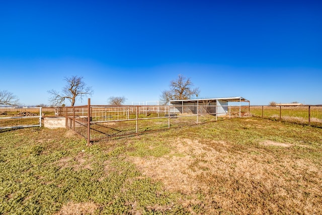 view of yard featuring an outbuilding and a rural view