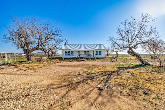 view of front facade featuring a rural view