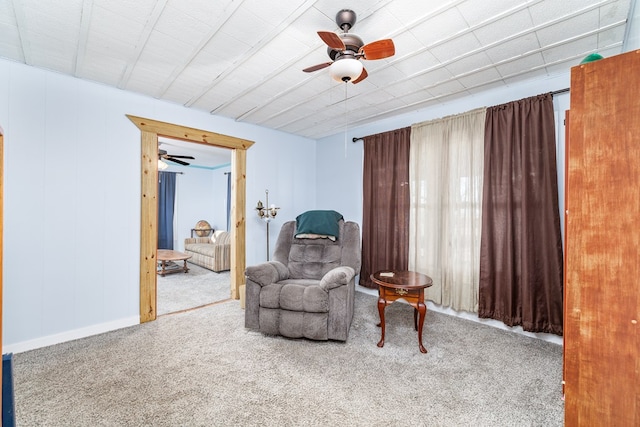 sitting room featuring ceiling fan and carpet