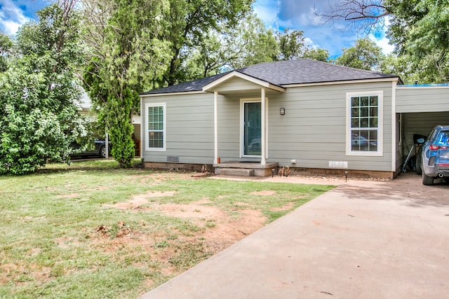 213 Paint Rock Rd, San Angelo, TX 76903 - ranch-style home with a front lawn, driveway, an attached carport, and roof with shingles