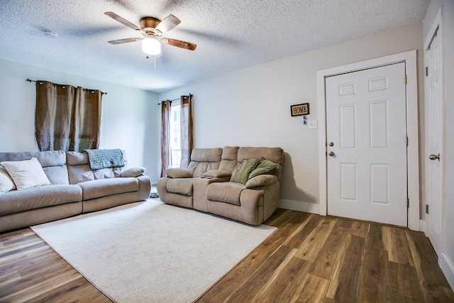 213 Paint Rock Rd, San Angelo, TX 76903 - living area featuring a ceiling fan, a textured ceiling, dark wood finished floors, and baseboards