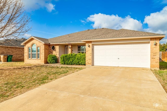 single story home featuring brick siding, a shingled roof, concrete driveway, an attached garage, and a front yard