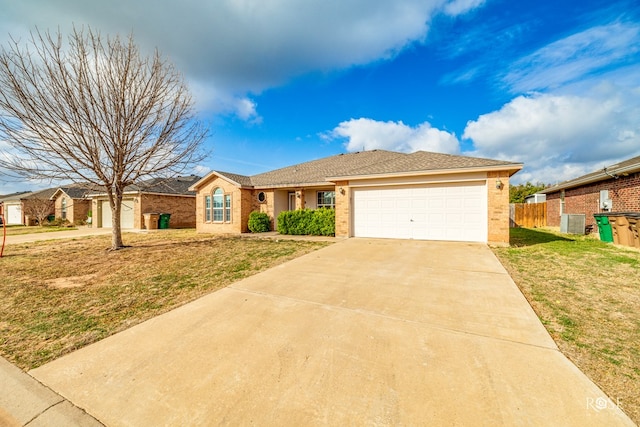 ranch-style house with driveway, a garage, fence, central air condition unit, and a front yard